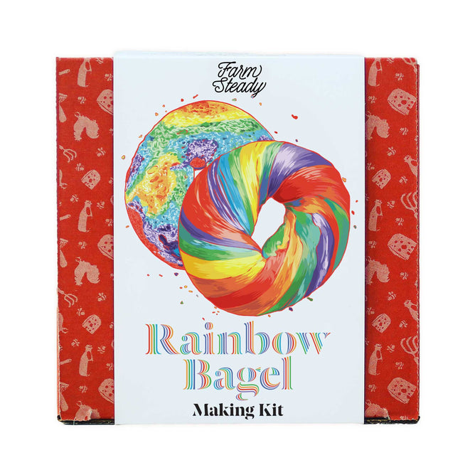The Rainbow Bagel Making Kit by FarmSteady is packaged with a striking swirled bagel on a white background, accented with a red icon pattern, inviting you to craft colorful and flavorful homemade bagels.