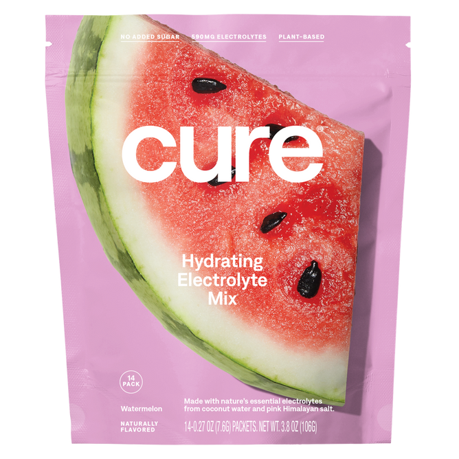 The pink package of Cure Hydrations Hydrating Electrolyte Drink Mix features a watermelon slice and highlights No Added Sugar, Electrolytes, and Plant-Based on the label. This watermelon-flavored mix promises rapid absorption, includes 14 packets, and weighs 3.8 oz (106g).