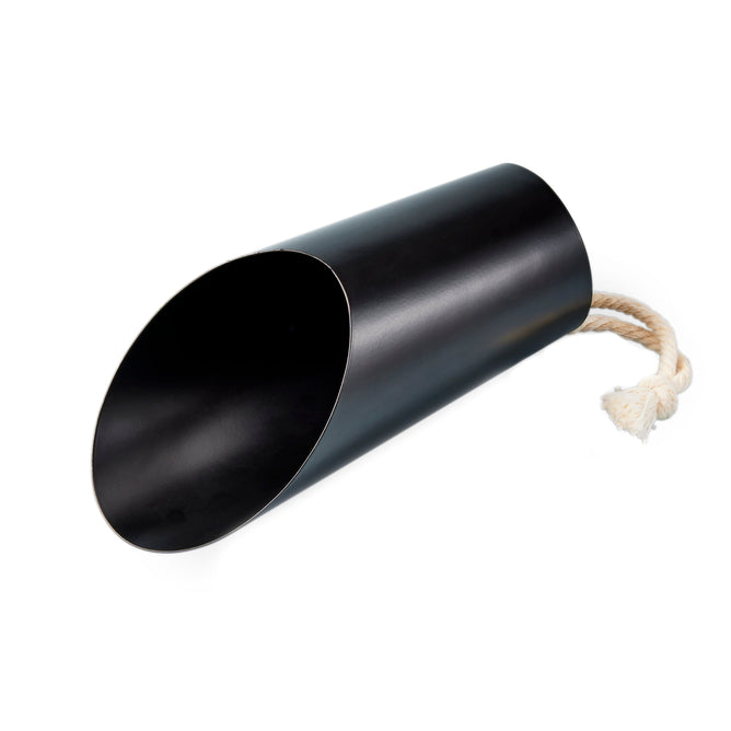 The Soil Scoop by Modern Sprout, with its matte black look and rope handle at the top, lies on its side. Its smooth, metallic finish gleams with an open end eagerly facing forward.