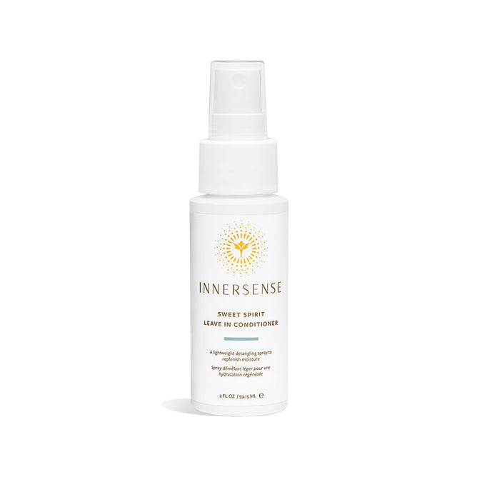 The Innersense Organic Beauty Sweet Spirit Leave-In Conditioner - Travel Size comes in a white spray bottle with a minimalist label and sunburst design. Enriched with aloe vera, this 2 fl oz (59.1 mL) detangler includes a clear cap for added convenience.