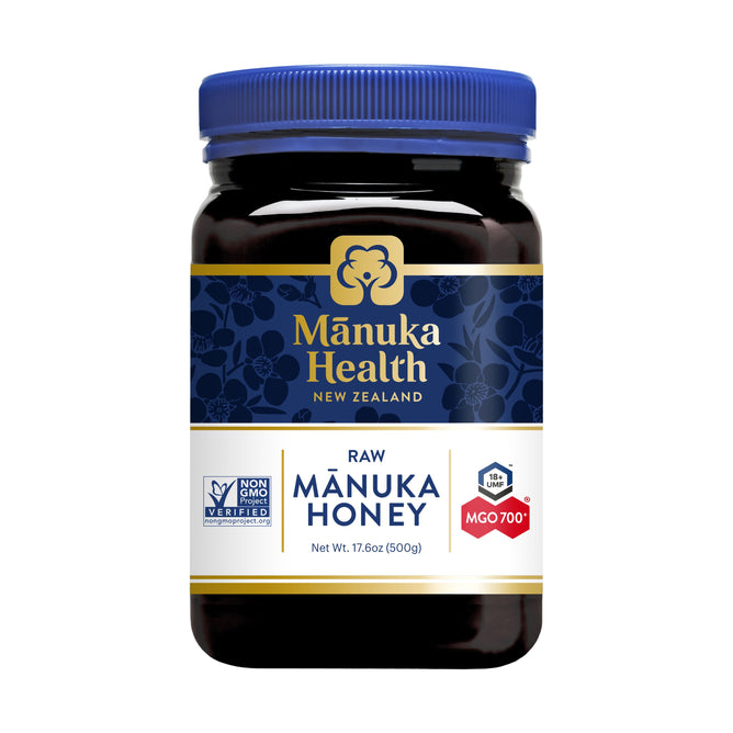 A 500g (17.6oz) jar of Manuka Healths non-GMO Manuka Honey, featuring a blue and gold floral label, boasts a UMF 18+ rating with MGO 700+, sourced from New Zealand.