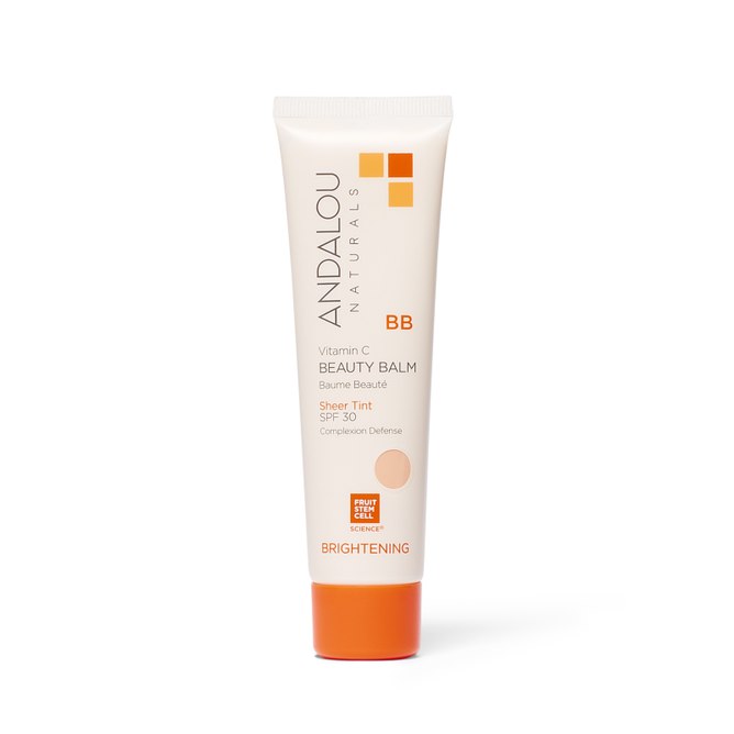 A white tube of Andalou Naturals Brightening Vitamin C BB Beauty Balm Sheer Tint SPF 30, featuring an orange cap, emphasizes its role as a brightening BB cream with hyaluronic acid for complexion defense.