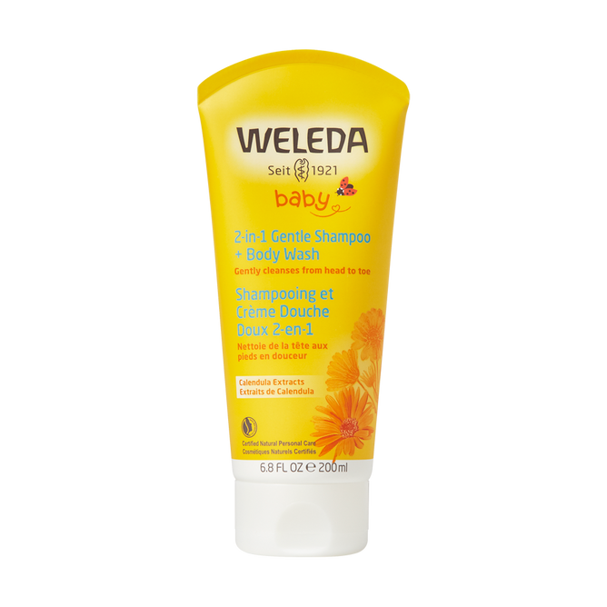 The 6.8 fl oz yellow tube of Weledas 2 in 1 Gentle Shampoo + Body Wash is enriched with calendula and sweet almond oil. The packaging features calendula flowers, highlighting its gentle cleansing properties.