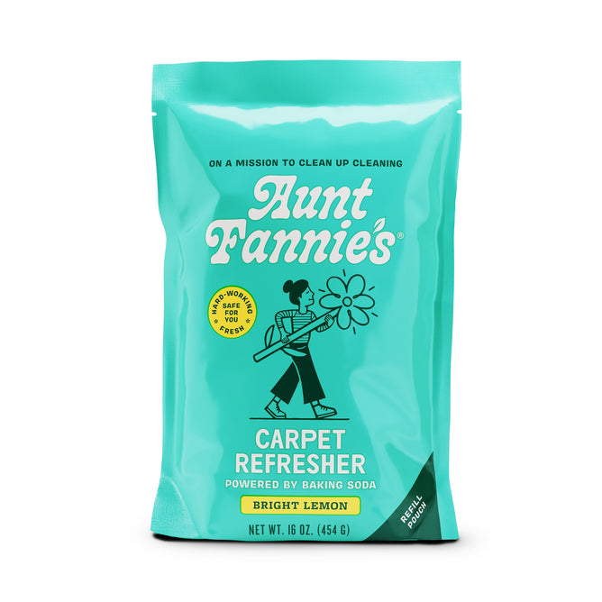 The teal packet of Aunt Fannies Carpet Refresher - Refill in bright lemon scent features essential oils, a vacuuming logo, and a baking soda formula described as good, workable food for fungi. It is vegan-friendly and has a net weight of 16 oz (454 g).