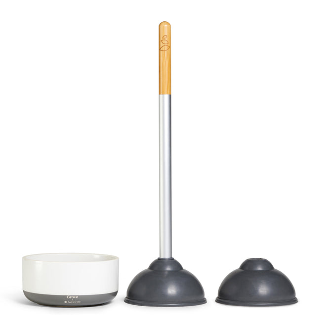 The Grove Co. Eco Plunger set, Buy 1 Eco Plunger, Get 1 Replaceable Rubber Head Free, features a white and gray design with a wooden handle, two interchangeable rubber heads, and a sleek white storage base.
