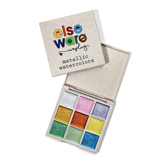 A 9-color set of metallic watercolors by Elseware Unplug in an eco-friendly bioplastic palette. The lid, marked with elseware and metallic watercolors, reveals pearlescent pigments in silver, gold, copper, pink, orange, green, blue, teal, and purple.