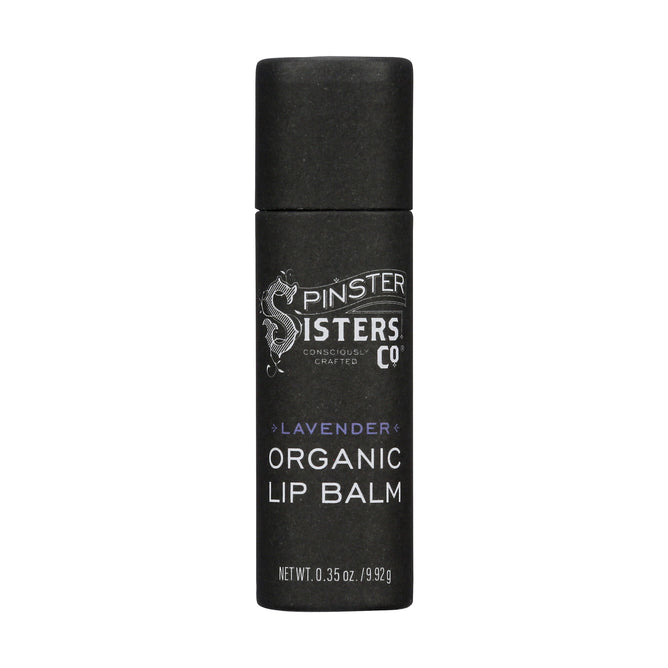 The black cylindrical Lip Balm by Spinster Sisters Co. features an intricate design, is USDA Organic certified, and contains soothing beeswax and coconut oil, with a stated weight of 0.35 oz./9.9 g.