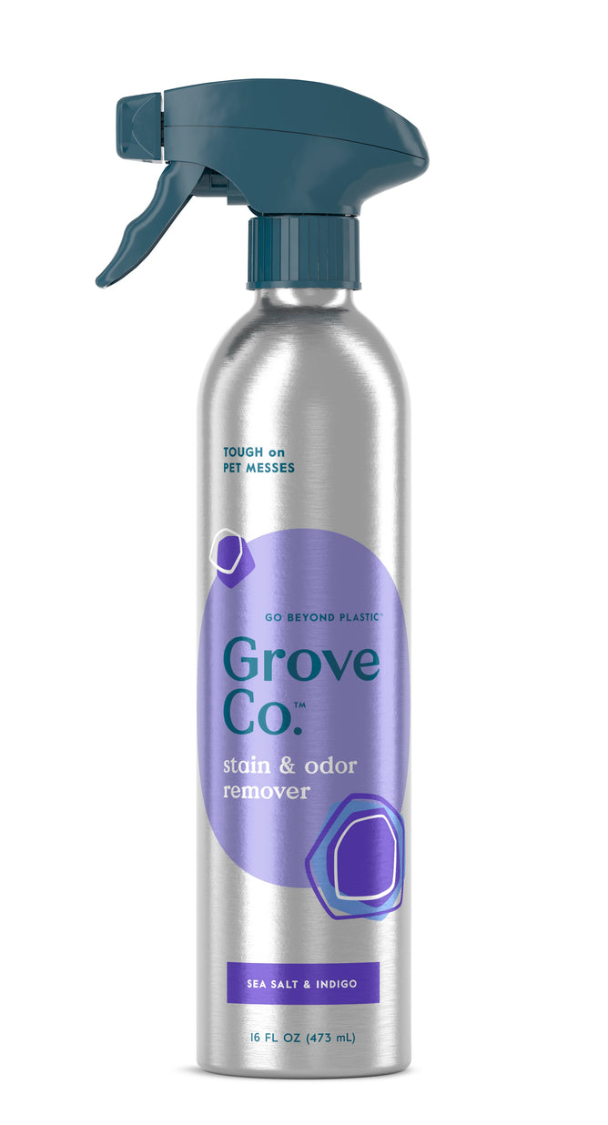 A 16 fl oz (473 ml) silver bottle from Grove Co. of Carpet & Upholstery Stain Remover, with a sea salt and indigo scent. Effective on pet messes, it features a dark teal spray nozzle and is listed as a VIP Discount product.