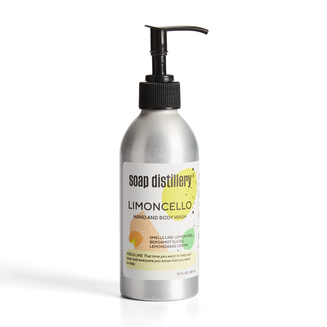 An 8 fl oz aluminum bottle of Soap Distillery Hand + Body Wash with a reusable black pump features citrus graphics, highlighting lemon peel, bergamot, and lemongrass scents.