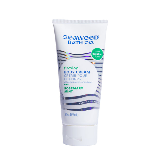 A 6 fl oz tube of The Seaweed Bath Co Firming Body Cream, enriched with rosemary, mint, and bladderwrack seaweed. It features a sleek white design with blue and green accents and a new awaken look sticker near the top.