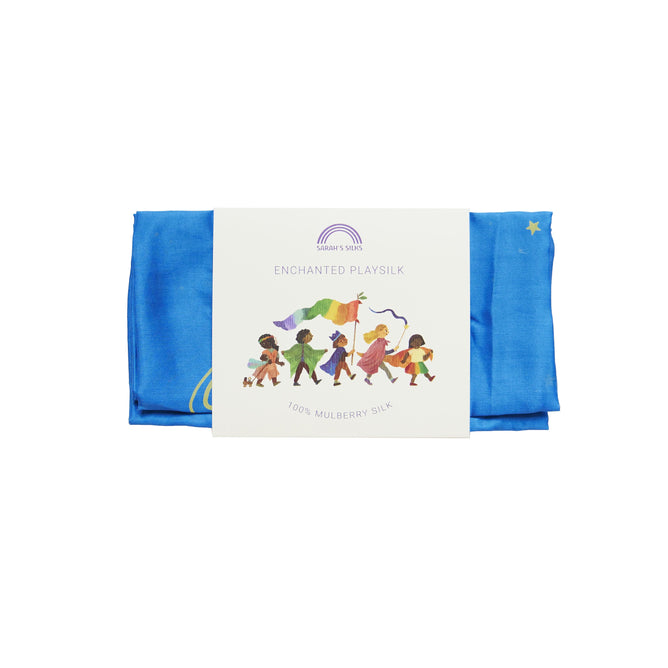 A folded blue playsilk labeled Enchanted Playsilk for Open-Ended, Imaginative Play by Sarahs Silks showcases diverse children playfully using vibrant fabrics. Made from 100% Mulberry Silk, it features a small twinkling star.