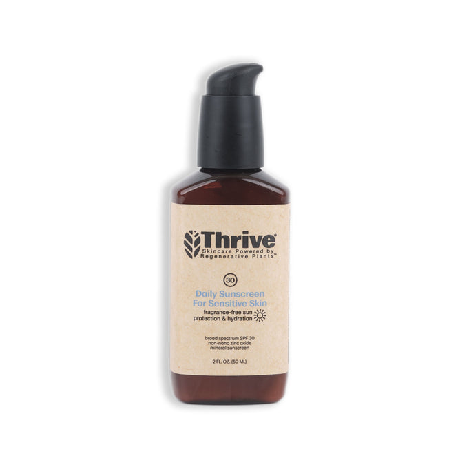 Thrive Natural Cares Daily Sunscreen for Sensitive Skin (SPF 30) comes in a brown bottle with a black pump dispenser and brown label highlighting fragrance-free and broad spectrum UVA/UVB protection. It features non-nano zinc oxide and is set against a plain white background.