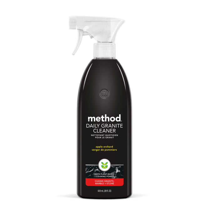 Methods Daily Granite Cleaner in an apple orchard scent comes in a black 828 ml (28 fl oz) bottle with a white nozzle, perfect for cleaning granite, marble, and stone countertops.