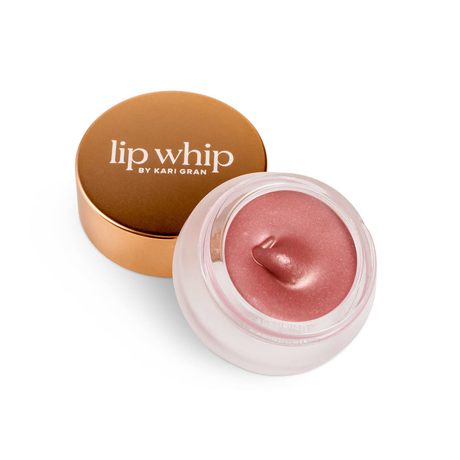 An open jar of Kari Grans Lip Whip - Peppermint Blush, featuring a bronze lid beside it, reveals its smooth, glossy texture—ideal for anyone looking for an organic lip care solution.
