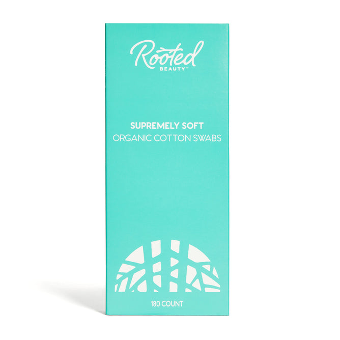 Rooted Beautys Cotton Swabs with Organic Cotton come in turquoise packaging with white text reading Supremely Soft Organic Cotton Swabs. A tree root design underscores their sustainable ethos. Hypoallergenic and perfect for eco-friendly bathing, the box contains 180 swabs.