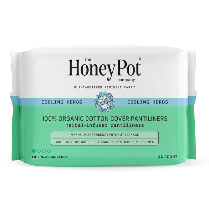 A pack of The Honeypot Company 100% Organic Cotton Cover Pantiliners includes 30 herbal-infused liners featuring cooling herbs and essential oils, with white and green packaging for maximum absorbency.