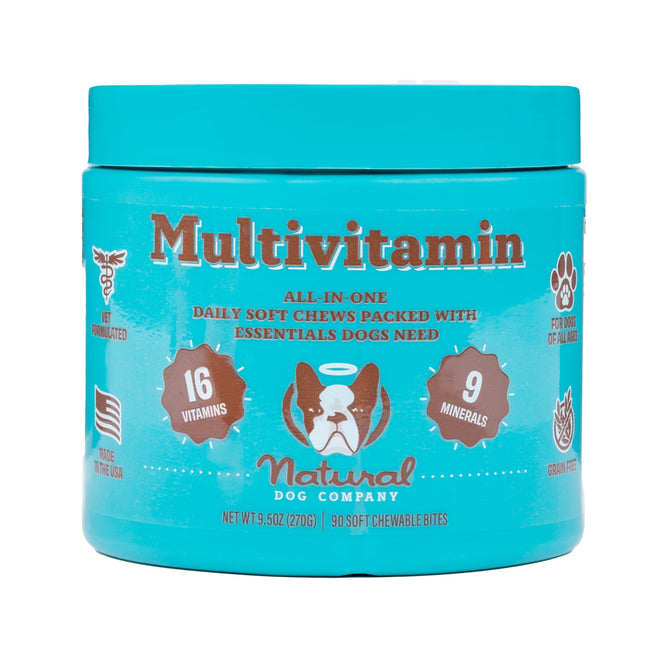 A turquoise jar features Natural Dog Company’s Multivitamin for Dogs, with a dog face illustration. Offering immune support, it contains 16 vitamins and 9 minerals. Labels include Daily Soft Chews, Not Sedated, Made in the USA, Grain-Free. Includes 90 soft chewable bites.