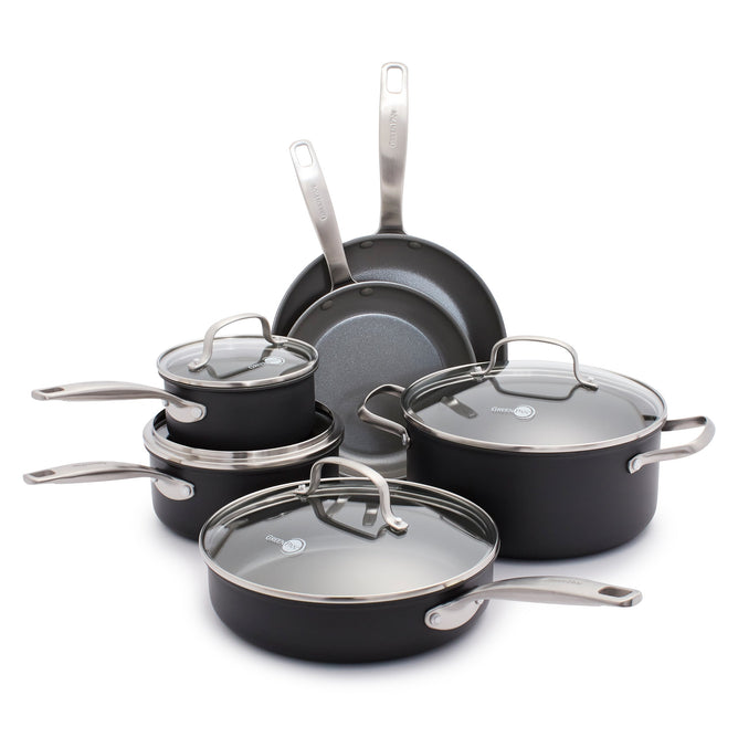 The GreenPan Chatham Ceramic, Non-Stick Cookware Set in sleek black includes two frying pans, two PFAS-free saucepans with glass lids, and a large pot. The pots feature a metal brushed finish with Thermolon ceramic nonstick surfaces and are displayed neatly on a white surface.