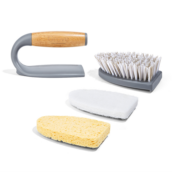 Introducing the Grove Co. Tub Buster Handle + Set of Three Heads, designed for efficiency and sustainability with a curved handle featuring a wooden top made from recycled plastic. This sleek set includes detachable brush heads with stiff bristles, a white scrub pad, and a yellow sponge.