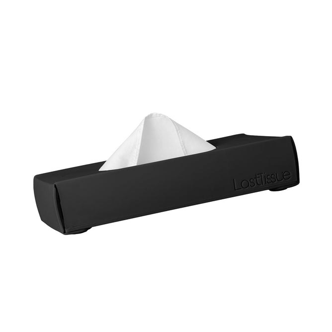 A sleek black rectangular LastTissue Box by LastObject, with a white tissue partially pulled from the top, encased in a silicone case for eco-friendliness.