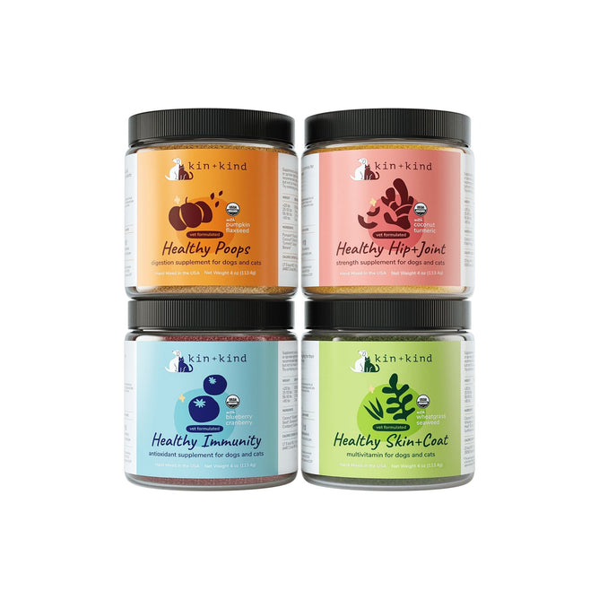 The Superfood Supplement Set by kin+kind features four USDA Organic jars: Healthy Poops, Healthy Hip+Joint, Healthy Immunity, and Healthy Skin+Coat. Each is vibrantly designed with icons emphasizing Real Foods Nutrition for pet health support.