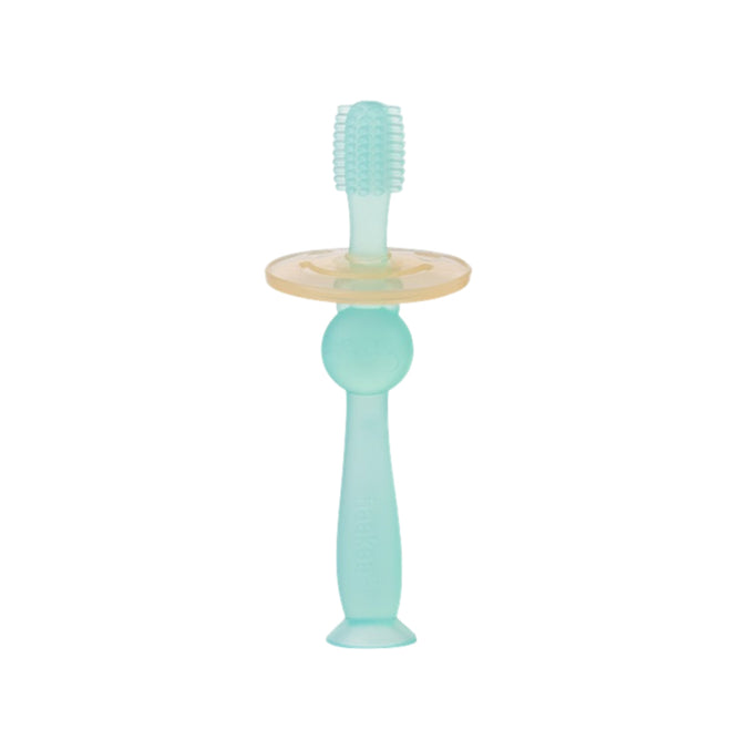 The Haakaa 360 Silicone Baby Toothbrush in teal, with a short rounded handle and yellow safety shield, prioritizes infants dental care. Featuring soft, rounded bristles ideal for early hygiene habits, it is made from a rubber-like material designed for safe use by little ones.