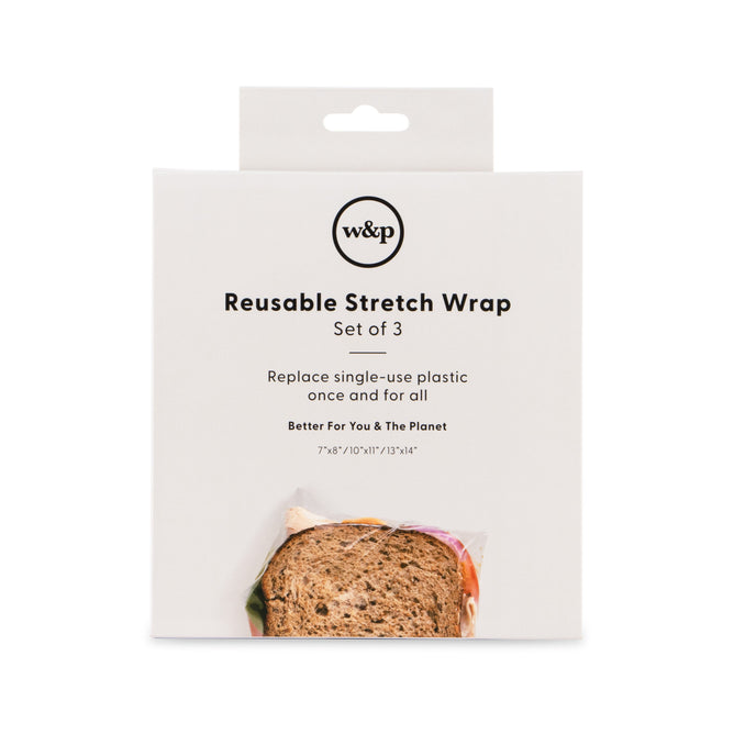 The product packaging for W&Ps Reusable Silicone Stretch Wrap, a set of three, highlights the transition to silicone wrap over plastic alternatives. The white box includes text and a partial image of a sandwich wrapped in the product at the bottom.
