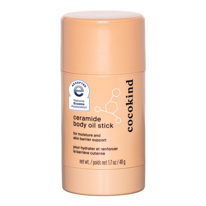 Beige cylindrical 48g Cocokind Ceramide Body Oil Stick with a blue National Eczema Association seal. Fragrance-free formula for moisture and skin barrier support, labeled in English and French.