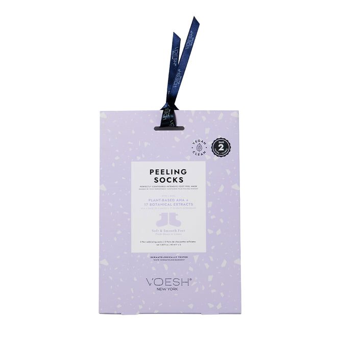 A rectangular purple package of VOESH New Yorks Peeling Socks Duo contains vegan ingredients and features plant-based AHA and 17 botanical extracts for exfoliation. A dark blue ribbon adorns the top, adding elegance.