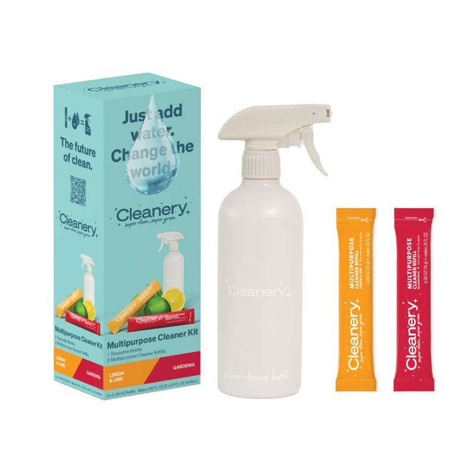 The Cleanery Multipurpose Starter Kit features a white spray bottle and two eco-friendly cleaning solution packets in lemon and geranium scents. The box slogan, Just add water. Change the world, emphasizes sustainability, with gardenia refills available for lasting freshness.
