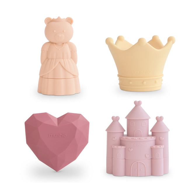 The mushie Princess Mold-Free Bath Toy Set – Soft Silicone includes four pastel toys: a princess bear, yellow crown, pink heart, and castle. Safe and mold-free, these food-grade silicone toys are ideal for fun bath time play.