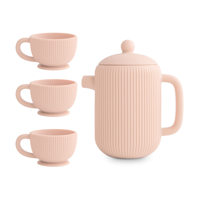 The mushie Silicone Tea Play Set includes three light pink cups and a matching teapot with lid, all BPA-free and designed with a modern ribbed texture—perfect for elegant tea time or pretend play.