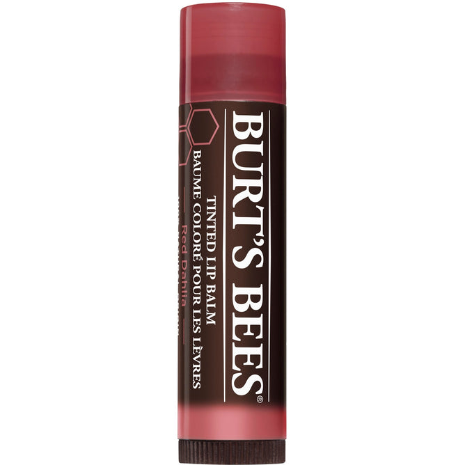 Burts Bees 100% Natural Tinted Lip Balm in Red Dahlia adds a pop of color, nourishing lips with natural moisturizers. The balm comes in a brown tube with a reddish cap, with the brand and product details displayed in white.