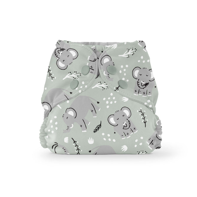 The Esembly Baby Outer Diaper Cover + Swim Diaper in Size 2 is made from 100% OEKO-TEX Certified recycled fabric. It features green cloth with cartoon elephants, leaves, and small white flowers. Snap buttons offer secure fastening, while elastic edges ensure a great fit, with playful gray elephants for charm.