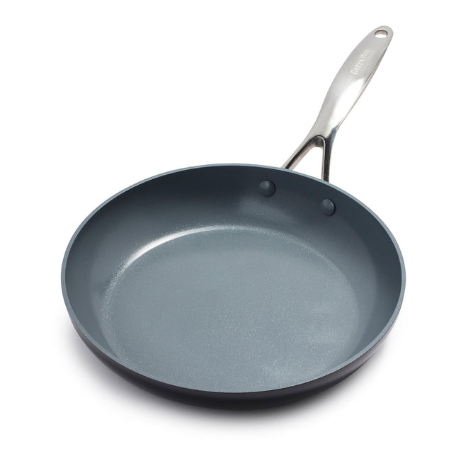 The GreenPan Valencia Pro Ceramic Nonstick Fry Pan, crafted from hard anodized aluminum, features a shiny silver handle angled to the right. Its dark gray coating ensures even cooking on a white surface and is PFAS-free for safe culinary adventures.