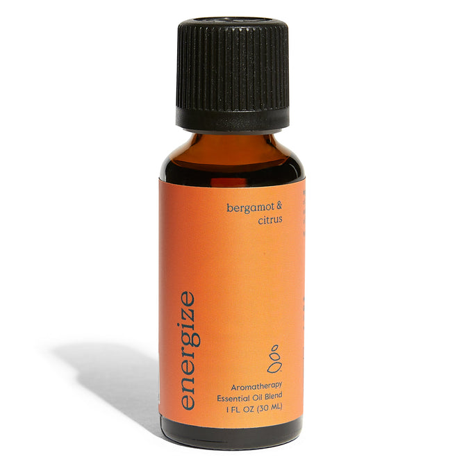 A 1 fl oz amber bottle by Grove Co. labeled in lowercase as energize with a black cap features an orange label saying bergamot & citrus containing an organic essential oil blend for aromatherapy.