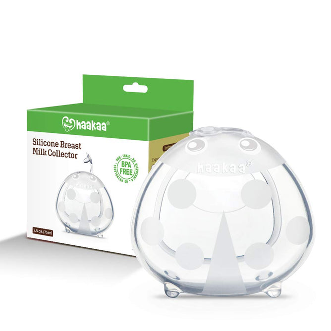 A clear, dome-shaped Ladybug Silicone Milk Collector with polka dots is displayed in front of its packaging. The green and white box highlights the Haakaa brand, promoting its BPA-free and eco-friendly design as an ideal alternative to breast pads.