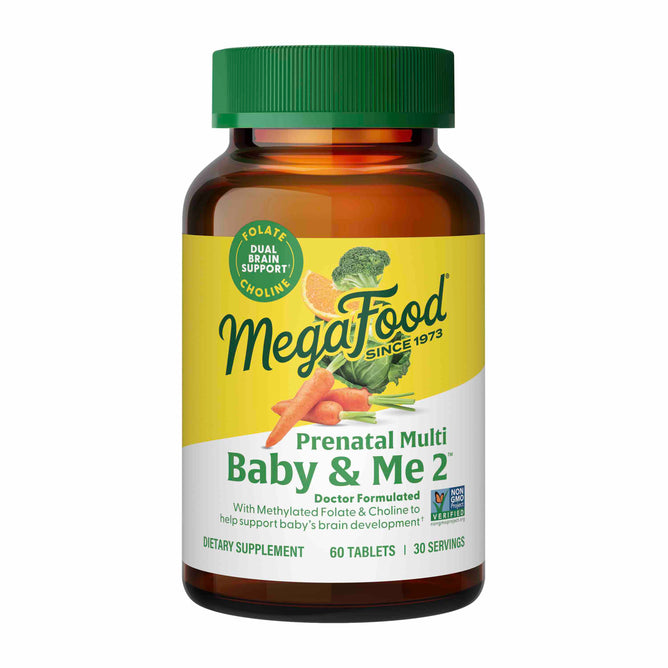 A bottle of MegaFoods Baby & Me 2 - Prenatal Multi, ideal for pregnancy support, offers dual brain benefits with folate and choline. It includes 60 tablets for 30 servings and is illustrated with carrots and an orange slice.
