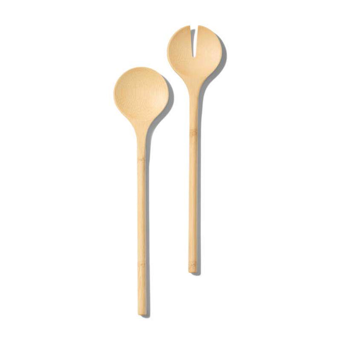 Grove Co.s Bamboo Salad Servers, FSC certified, are featured on a white background. One has a round spoon shape, and the other has a forked tip for efficient serving, combining sustainable style perfect for any eco-conscious kitchen.