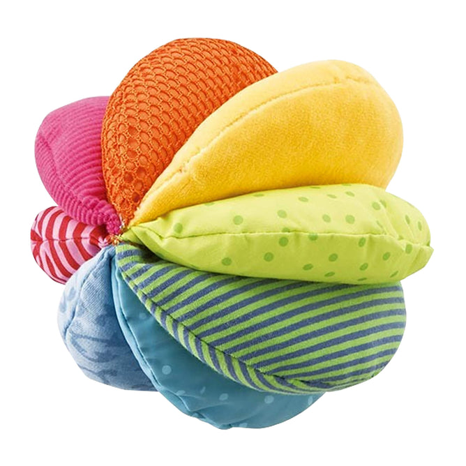 The HABA Rainbow Fabric Baby Ball features eight unique sensory textures, including red mesh and blue floral designs, promoting infant motor skill development.