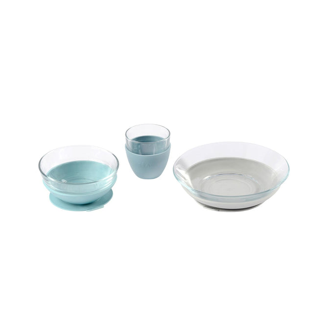 The BEABA 3-Piece Glass Suction Baby and Toddler Feeding Set includes an eco-friendly translucent blue bowl with suction base, a training cup with a lid, and a plate featuring a raised rim, ideal for little ones.