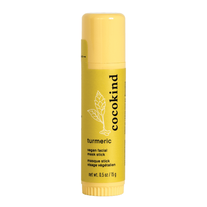 A 0.5 oz/15 g yellow tube of Cocokinds Turmeric Spot Treatment stands upright, featuring minimalist packaging with a leaf design. It includes organic ingredients like turmeric root powder for a natural skincare experience.