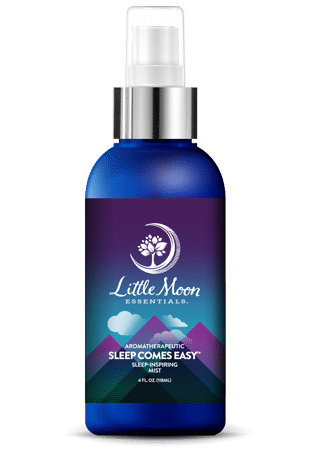 The Sleep Comes Easy - Mist by Little Moon Essentials is your ideal sleep-aid spray. It features a blue bottle with a silver nozzle and a label displaying a crescent moon and clouds over purple and teal mountains, all enhanced with the soothing power of essential oils.
