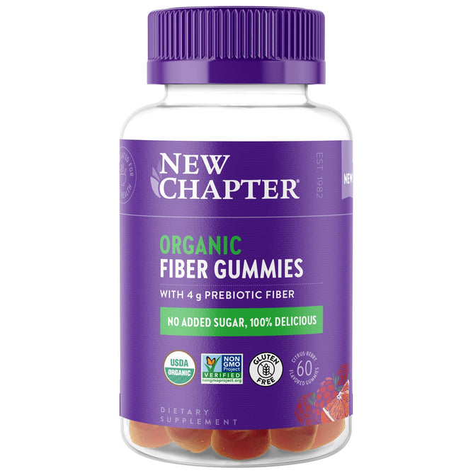 The New Chapter Organic Fiber Gummies come in a clear plastic bottle with a purple cap. The label highlights 4g of organic prebiotic fiber for digestive health, no added sugar, USDA organic, non-GMO, and gluten-free features. The bottle contains 60 gummies.