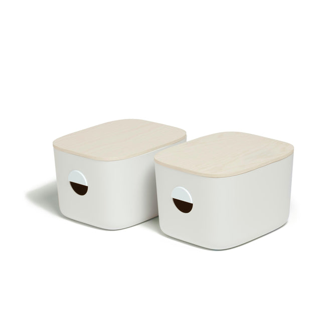 The Medium Storage Bins with wooden lids by Open Spaces are ideal for pantry organization. These white rectangular boxes feature circular cutout handles and rounded edges, blending style and functionality for chic multi-purpose storage solutions.