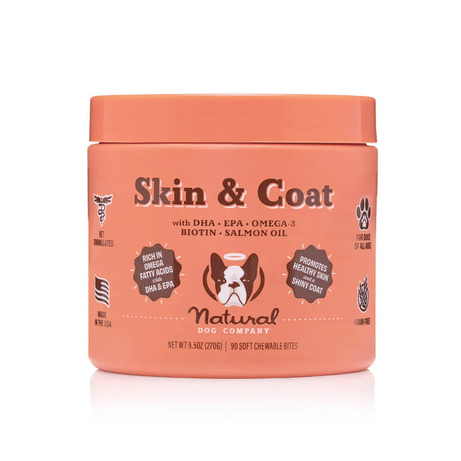 The Skin & Coat Supplement for Dogs by Natural Dog Company, in an orange container with a dog graphic, offers 90 soft chews with DHA, EPA, Omega-3, Biotin, and Salmon Oil to support your dogs skin and coat health.