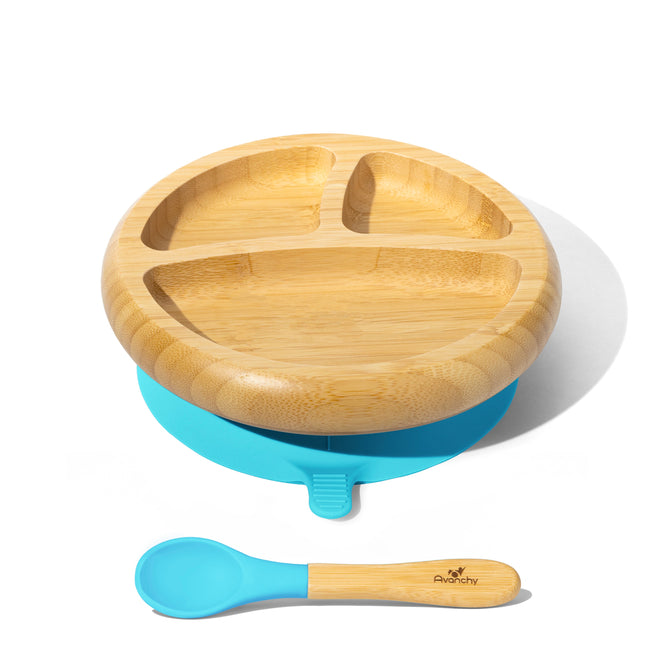 An Avanchy Bamboo Suction Baby Plate with three sections sits on a blue silicone base, accompanied by a matching bamboo and blue spoon. This eco-friendly set is perfect for high chairs and styled against a white background.