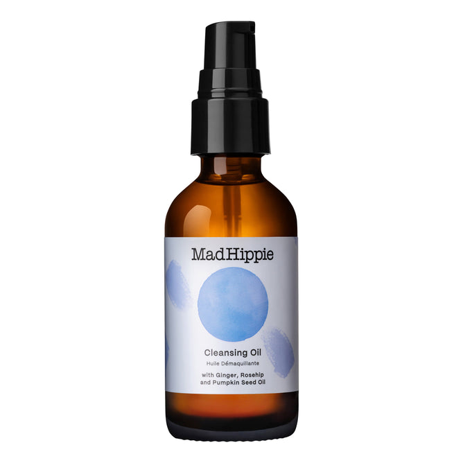 The Mad Hippie Cleansing Oil comes in a brown glass bottle with a black pump and blue circular designs, offering a refreshing cleanse using organic ingredients such as ginger, rosehip, and pumpkin seed oil.