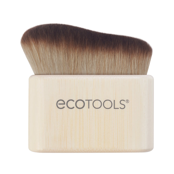 The EcoTools Body + Face Self-Tan Blending brush features dense, soft bristles that fade from dark brown to light beige. Its rectangular, round-edged handle is crafted from light wood and displays the EcoTools logo. This cruelty-free, vegan brush ensures a streak-free tan application.