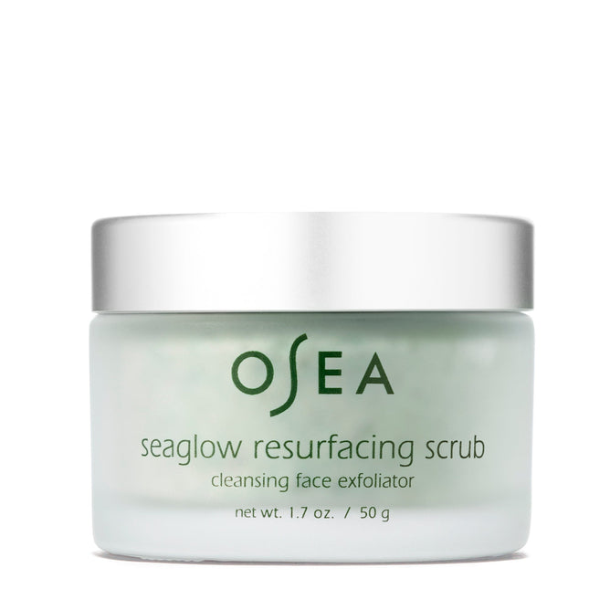 A 1.7 oz / 50 g jar of OSEA Seaglow Resurfacing Scrub with a silver lid, labeled cleansing face exfoliator, features a light green formula designed to exfoliate and reveal glowing skin.